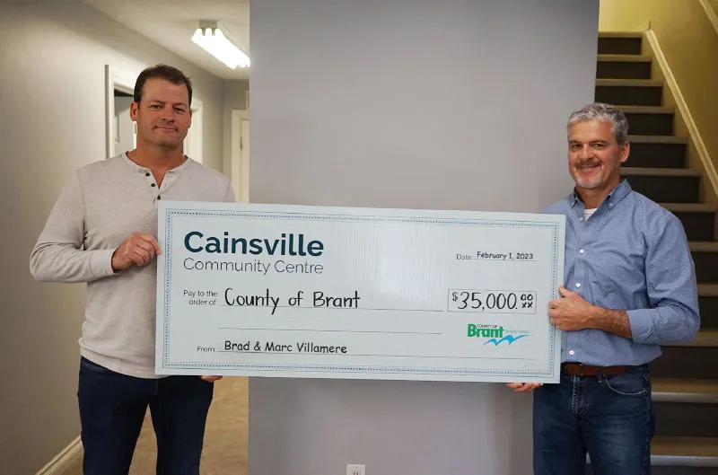 Brad and Marc Villamere presenting a $35,000 cheque for the Cainsville Community Centre