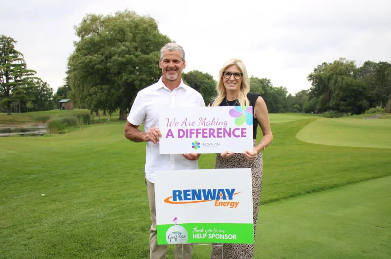 A Renway representative holding a Renway Energy sponsor sign beside a Nova Vita sign at a golf event