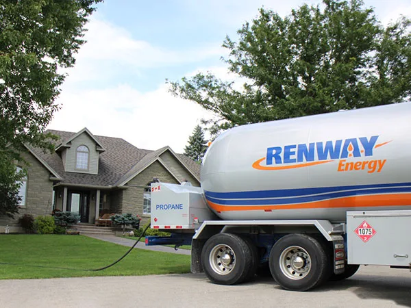 A Renway propane truck delivering to a stone house
